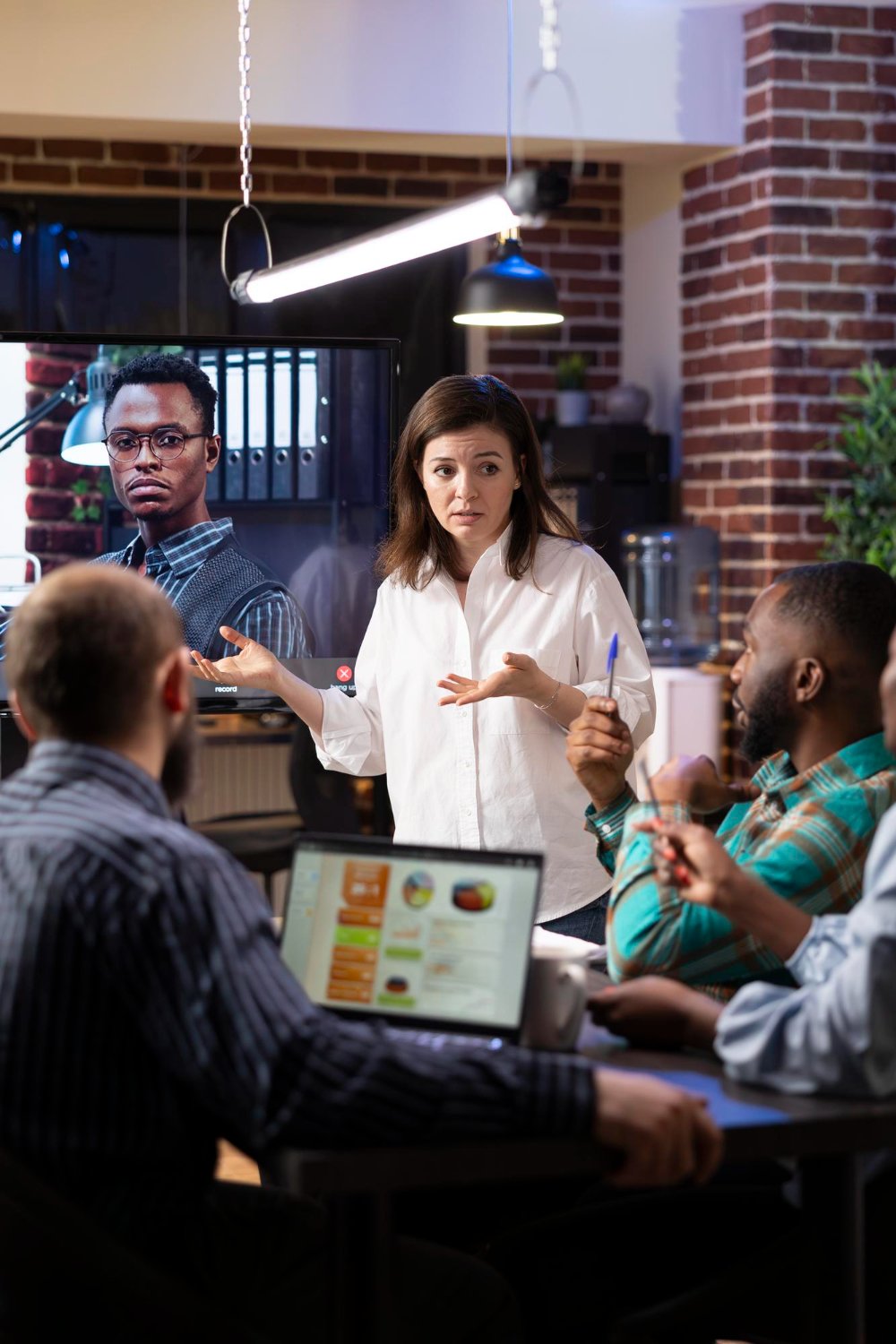 Coworkers engaged in a virtual meeting in an office for lead generation and business development