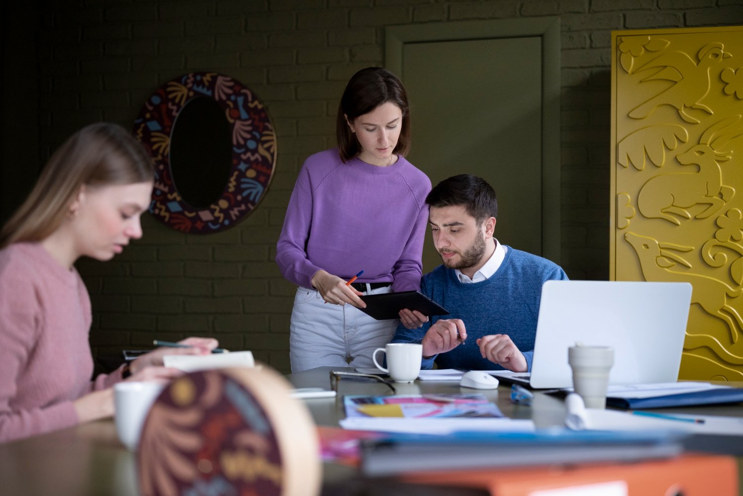 Medium shot of people working together in an office setting