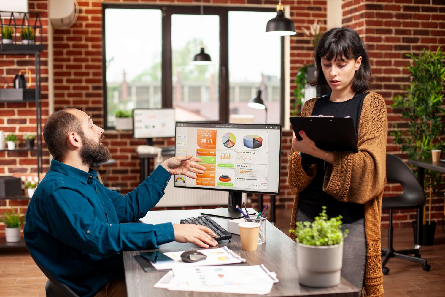 Woman explaining project ideas to coworker in modern office collaboration
