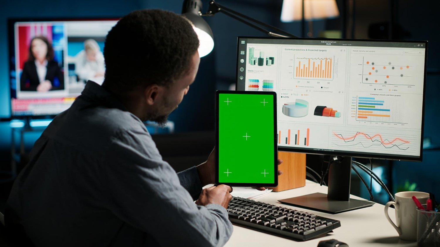 Young man examining financial data on a tablet with a mockup display for investment or fintech analysis